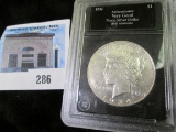 1934 D U.S. Peace Silver Dollar in a black lined clear plastic case.