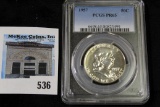 1957 P Franklin Half Dollar slabbed “PCGS PR65”.