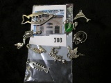 Group of ten (10) sterling silver charms, includes fish, pelicans, turtles, swordfish, alligator, se