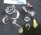 Group of eleven (11) sterling charms, includes flip-flops, sun & moons, Native American bears, group