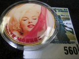 Marilyn Monroe Golden Medallion depicting Marilyn in red stockings on one side & nude without colori