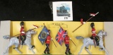 Group of 4 BRITAINS metal toy soldiers, 2 flag bearers, 2 horse-mounted soldiers, still affixed to o