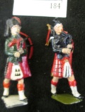 Pair of metal Scottish bagpipe players, marked BRITAINS