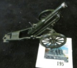 Metal toy cannon - green, two wheeled, horse-drawn style, marked BRITAINS MADE IN ENGLAND, spring lo