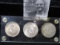 Capital style holder containing three 1846-1946 Iowa Centennial Commemorative Silver Half Dollars. A