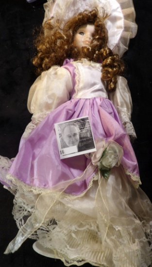 Over 16" tall Doll with lavendar and lace dress and hat. Complete with stand.