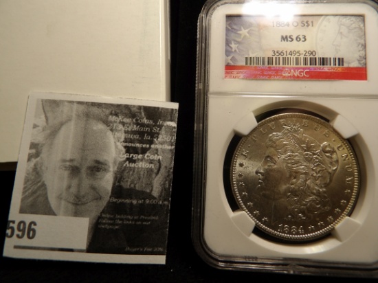 1884 O Morgan Silver Dollar NGC slabbed MS 63 and stored in a velvet-lined box.