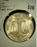 One Troy Ounce .999 Fine Silver, design is with flying Eagle and Balance scale.