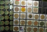 (52) various Wooden Nickels from Iowa in a pair of plastic pages.