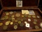 Collection of Old Coins in a felt-lined Wooden Box. Includes a Silver U.S. Peace Dollar.