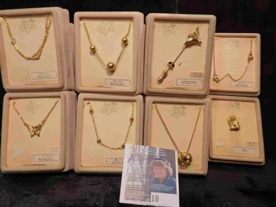 Collection of 8 different necklaces and pins in original Boxes. Retail value was over $50.00.