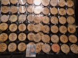 (40) Nebraska Wooden Nickels in a pair of plastic pages.