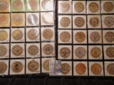 (40) Nebraska Wooden Nickels in a pair of plastic pages.