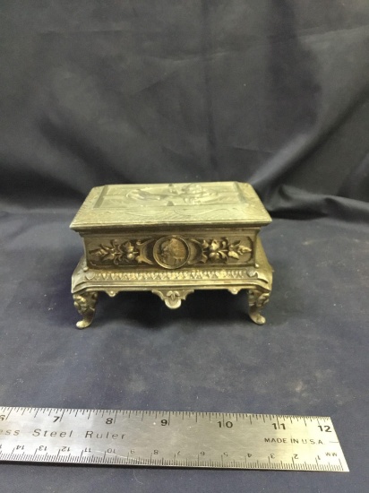 Vintage metal jewelry box or casket with cherub figure on top