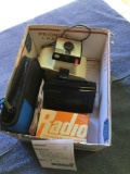Box of miscellaneous AM/FM radio GE miniature radio old Polaroid camera CD case