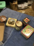 Group of five sealed collectible tins