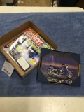 box of miscellaneous car magazines in frame picture of blue motorcycle