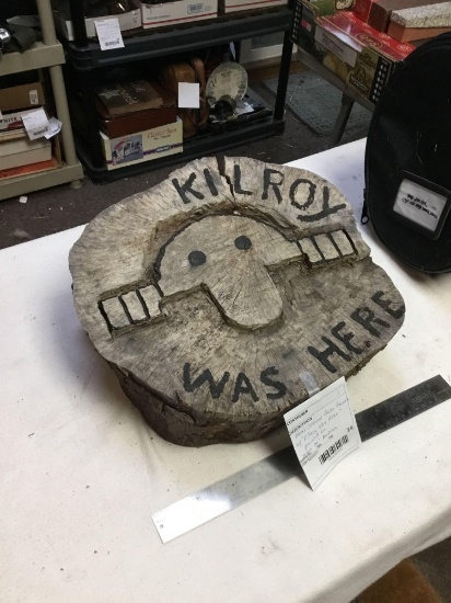 hand carved tree trunk with Kilroy was here painted on