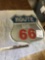 route 66 metal sign glows in headlights