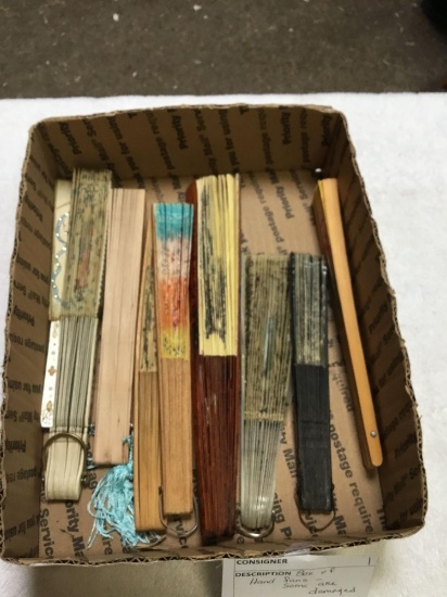box of hand fans, some are damaged