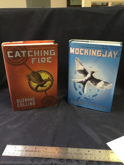 Two piece books by Suzanne Collins the Mockingjay and catching fire