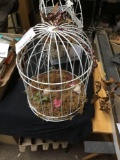 round white metal hanging birdcage with birds inside