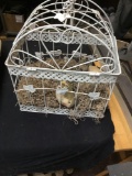 hanging white metal birdcage with porcelain birds