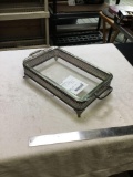 large glass casserole dish with metal footed holder