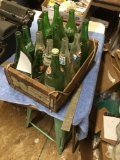 wooden crate with Sprite, 7-Up, and Pepsi bottles
