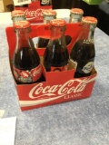 vintage, six piece Coca-Cola glass bottles with carrying case for miscellaneous advertisements