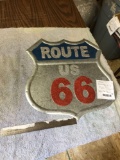 route 66 metal sign glows in headlights