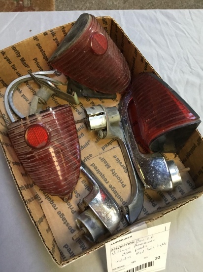 box of vintage American car parts includes red, tail lights