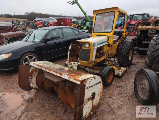 International Cub lowboy tractor with belly mower and front snowblower