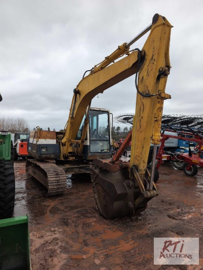Komatsu PC100 excavator with bucket, mechanical thumb, cab, runs and operates fine, tracks are stiff