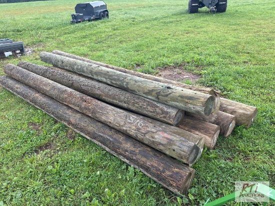 Pile of (10) mixed length telephone poles.