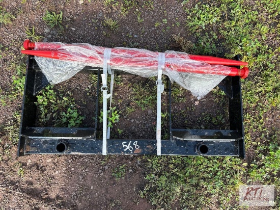 Dual prong bale spear for skid loader.
