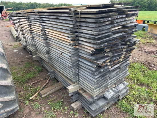 Approximately (90) pieces of 12in x 14ft rough cut lumber. Quantity and measurements are estimates.