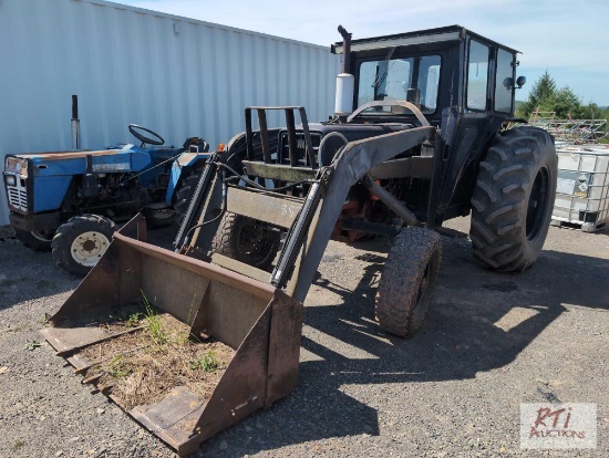 International 574 tractor with cab and loader.