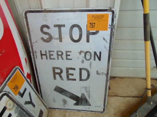 "STOP HERE ON RED" SIGN
