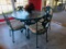Cast Iron Table W/ Glass Top & 4 Matching Chairs