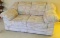 Light Multi-Colored Love Seat Sofa. Dixieland Manufacturing Company. Very good condition.