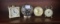 Four small alarm clocks one is Black Forest, Baby Ben, Westmoreland