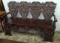 Very ornate highly carved four person Bench with heads and figural carved back, northwind head on ba