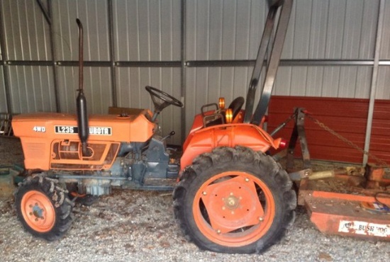 Kubota 235 4 wheel drive Tractor with bush hog and scraper blade in very good condition