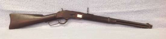 Model 1873 38 cal Winchester having saddle ring and original slide plate with adjustable sight , thi