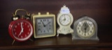 Four small Alarm Clocks