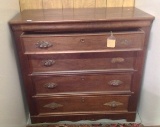 Four drawer 1800's Gentleman's Chest with carved wooden pulls, original finish and divided top drawe