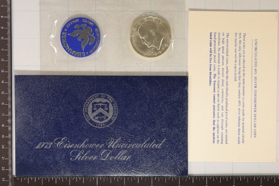 1973 IKE SILVER DOLLAR (BLUE PACK) AND PAPER WORK