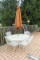 White Wrought Iron Table w/ (4) Chairs and Umbrella