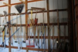 Assorted Hand Tools Behind Blue Ribbon- Shovels, Rakes, Brooms